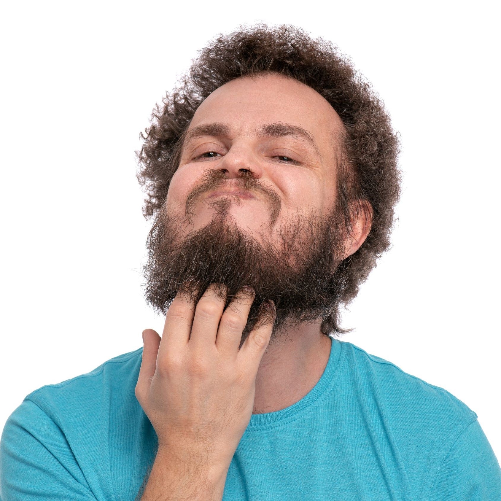 Man with curly hair scratching messy beard