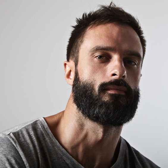 Bearded man with hair held by pomade