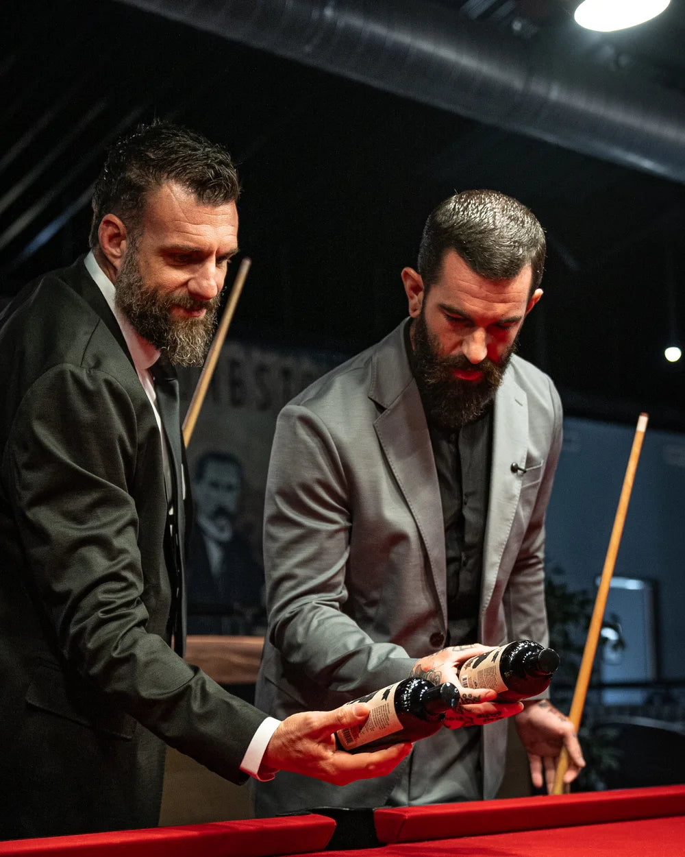 Johnny Slicks CEO Nick Koumalatsos and founder John Raushi with Black Label bottles at a pool table